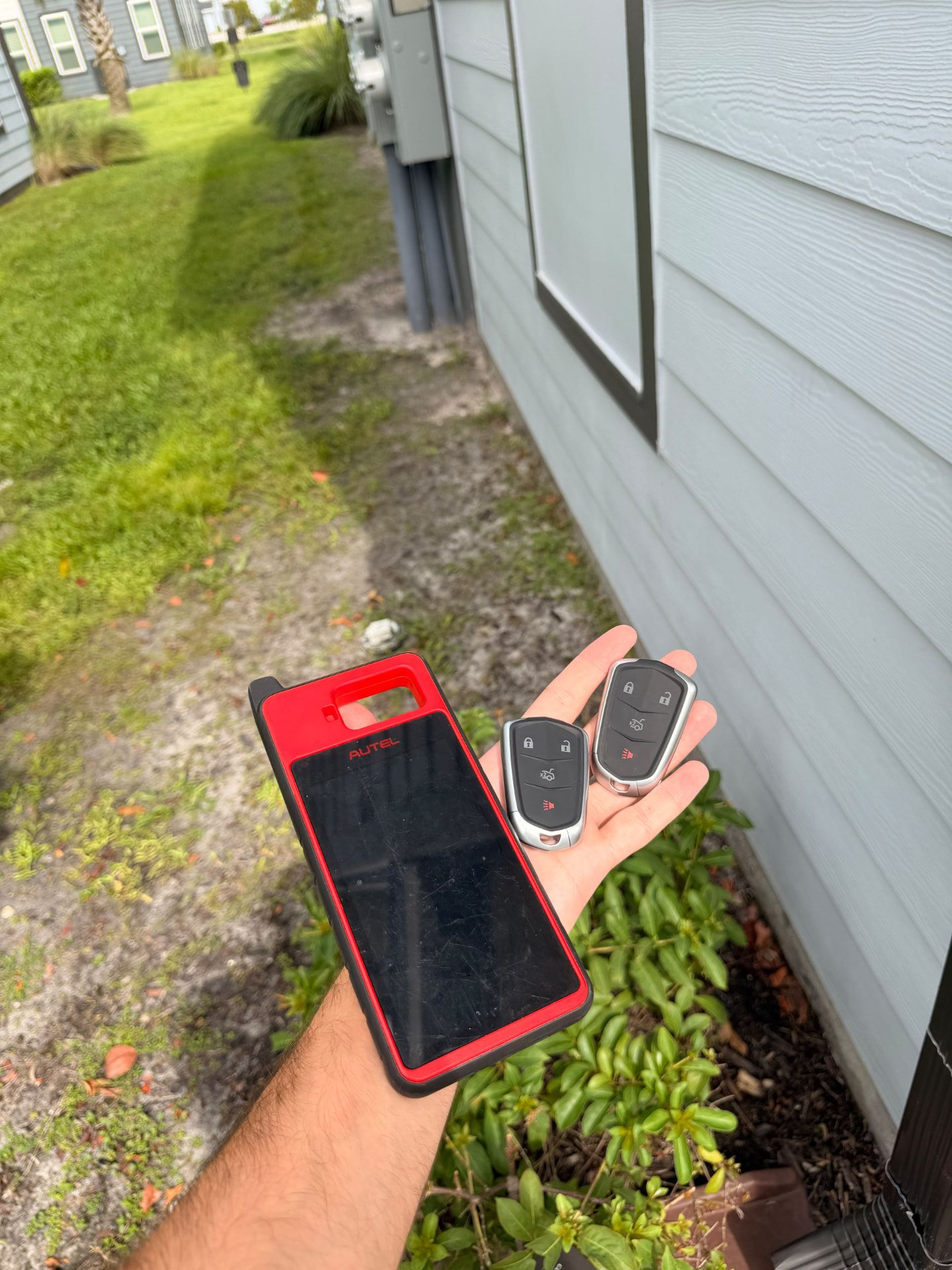 Vehicle key fobs beside a diagnostic tablet; not a remote-start compatibility demonstration