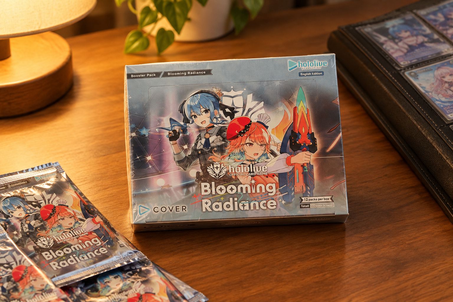 Sealed Blooming Radiance hololive booster box on a collector's desk