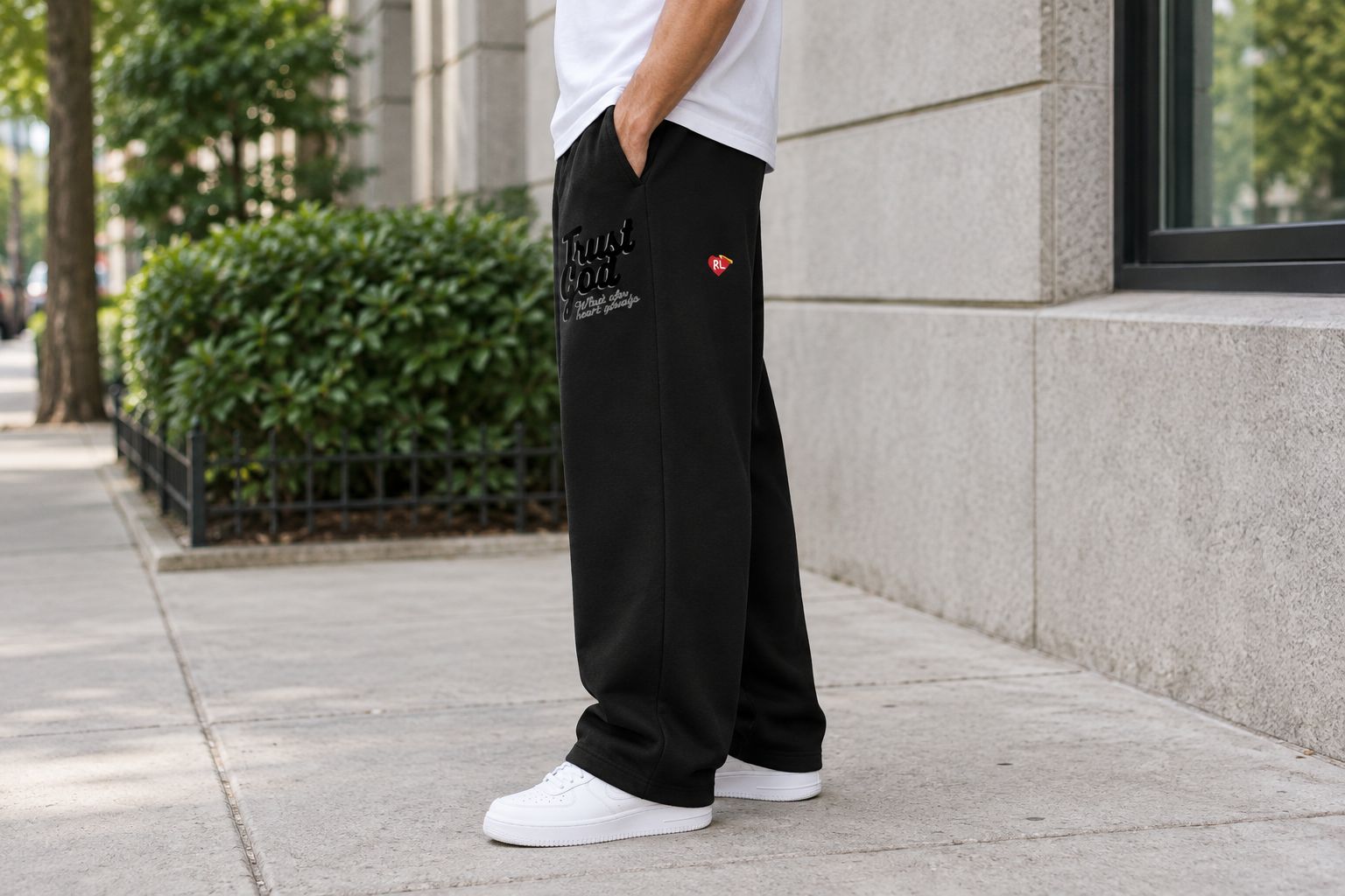 Side view of sweatpants worn with a plain tee and sneakers