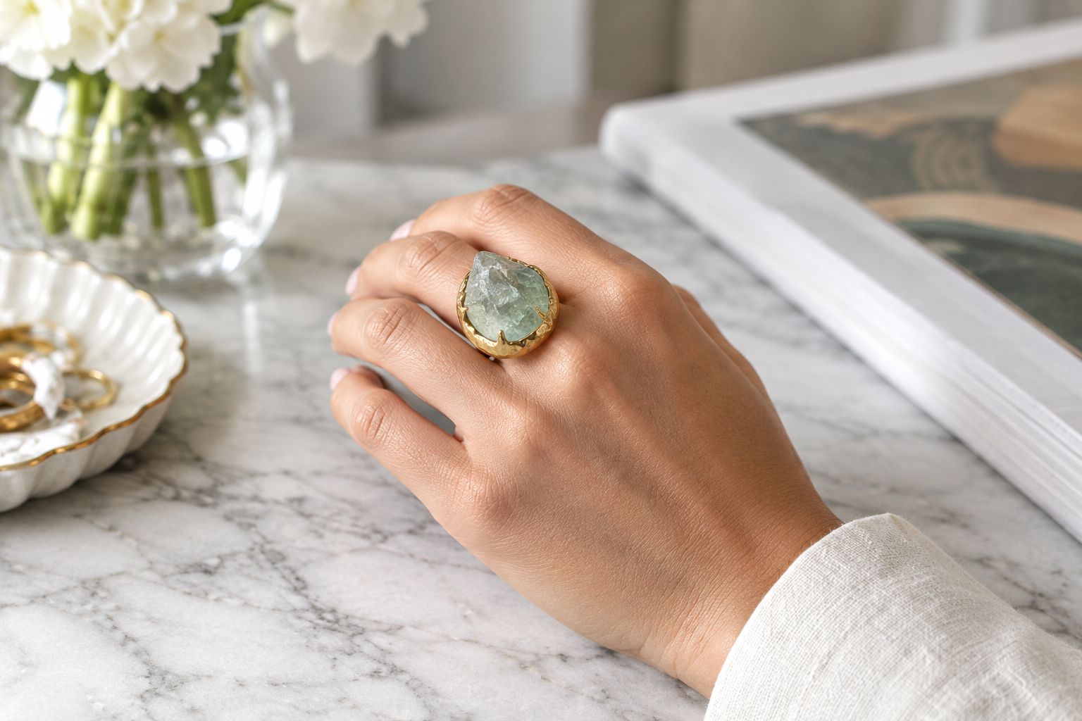 Hand wearing a large raw-gemstone cocktail ring