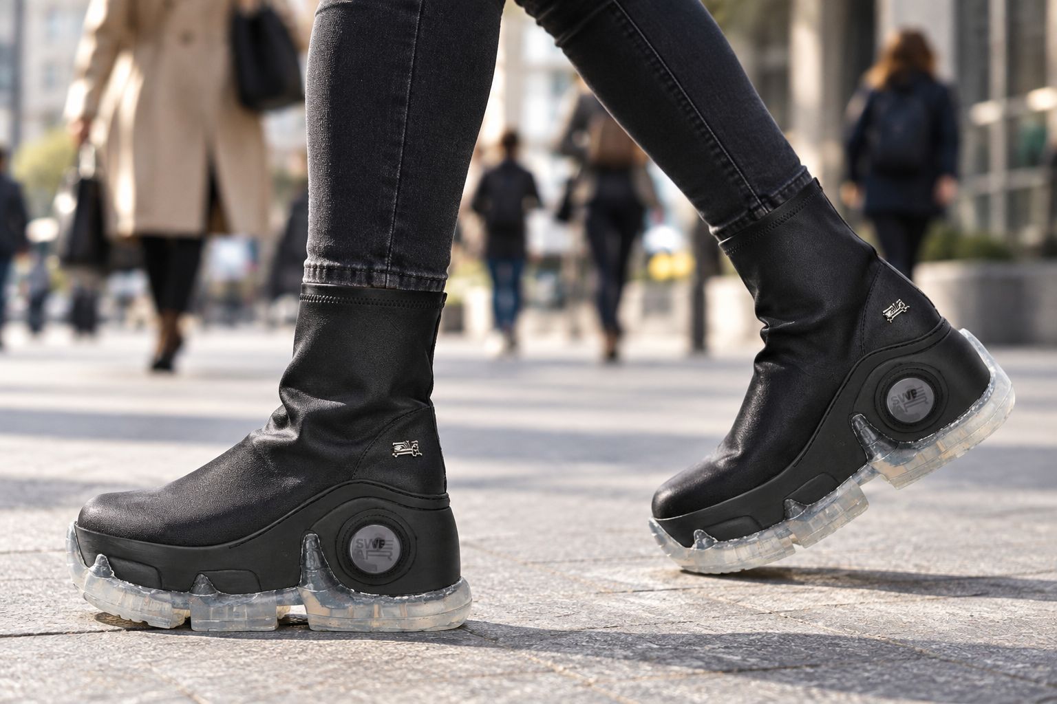 Woman wearing black vegan platform trainers walking through a city street