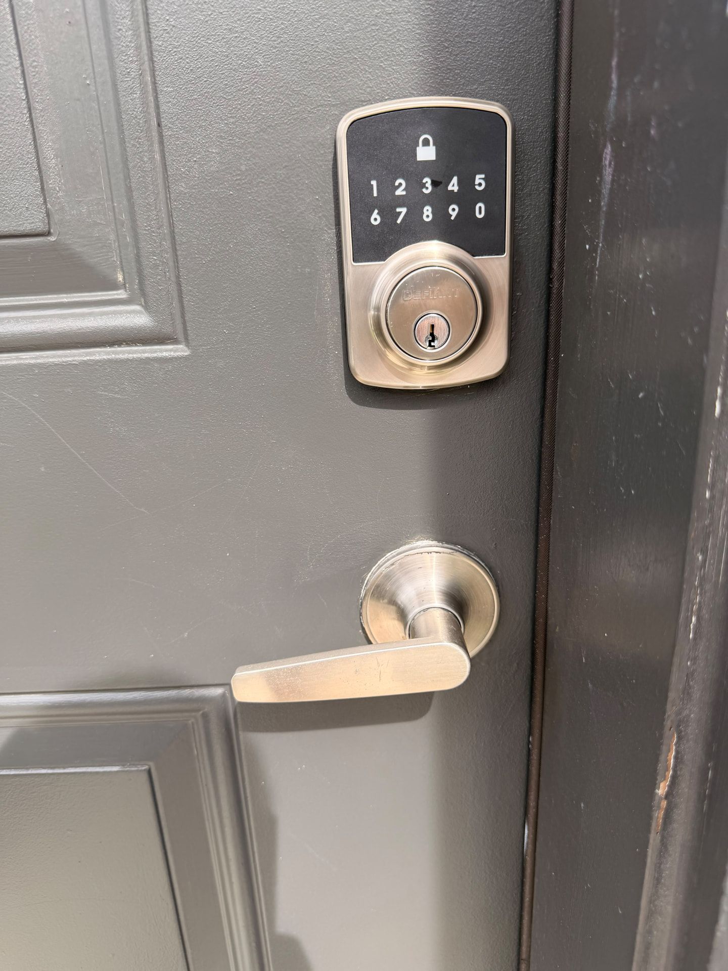 Electronic keypad deadbolt above a door lever; connectivity is model-dependent