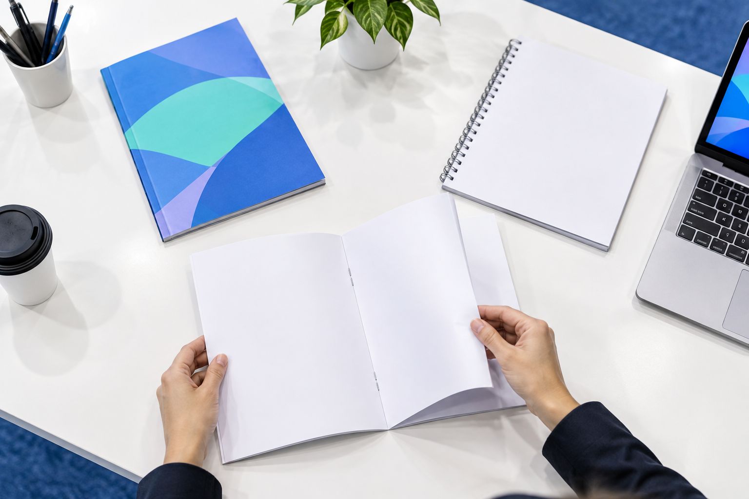 Hands checking sample booklet pages beside different binding formats