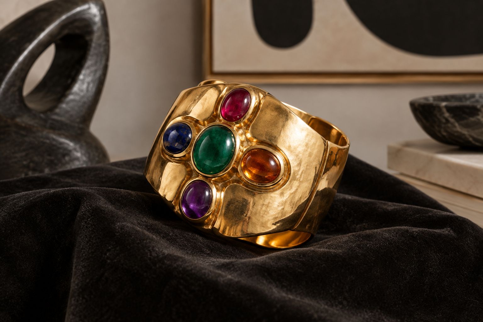 Sculptural gold cuff with a cross-shaped cabochon arrangement