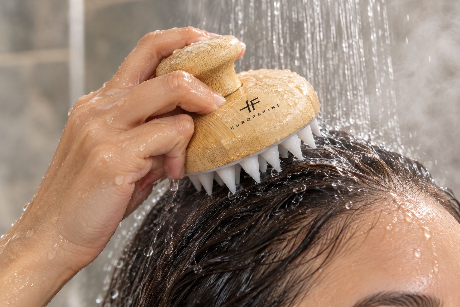 Scalp massage brush used in the shower with silicone bristles against the scalp