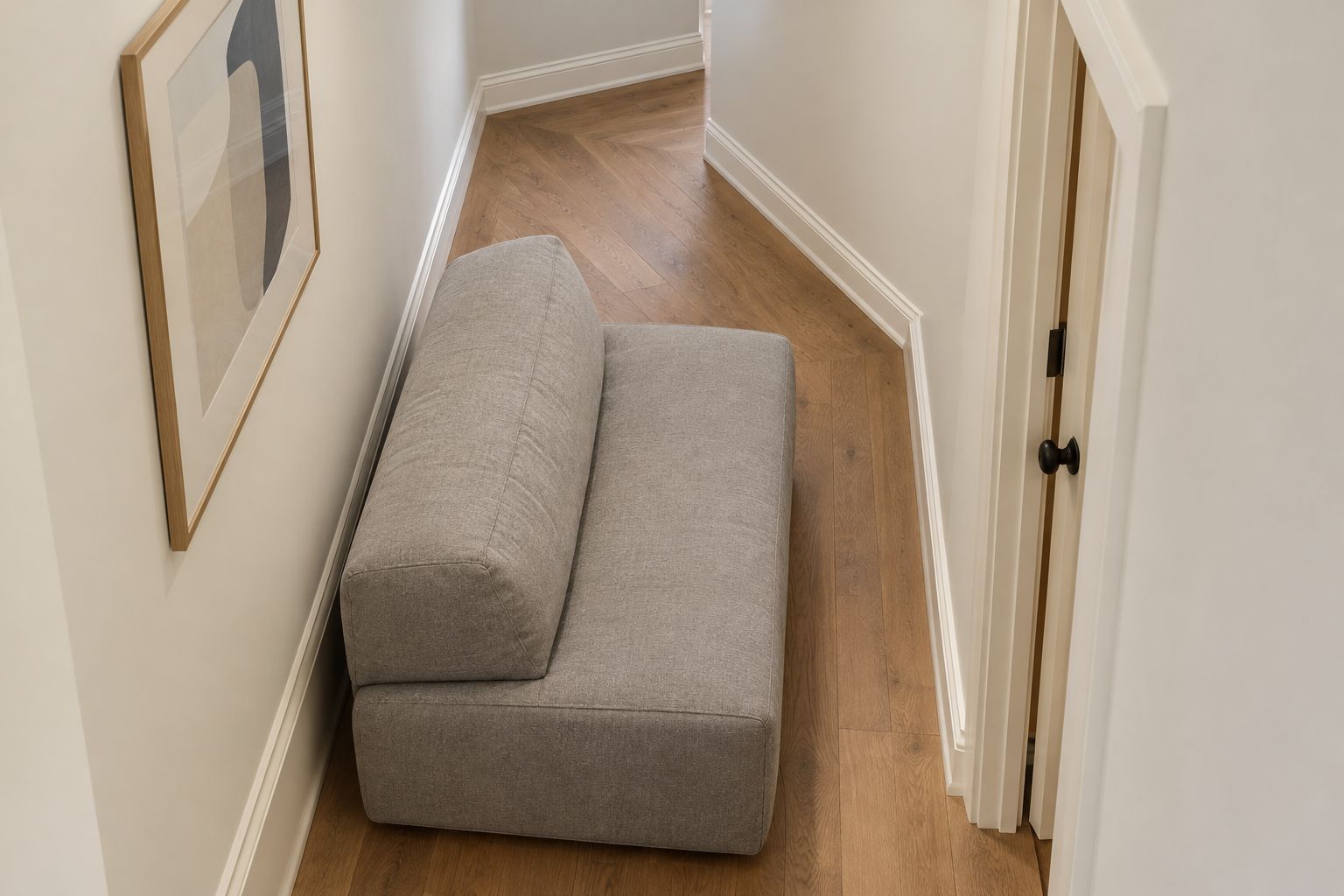 Low upholstered sofa module beside a tight hallway corner