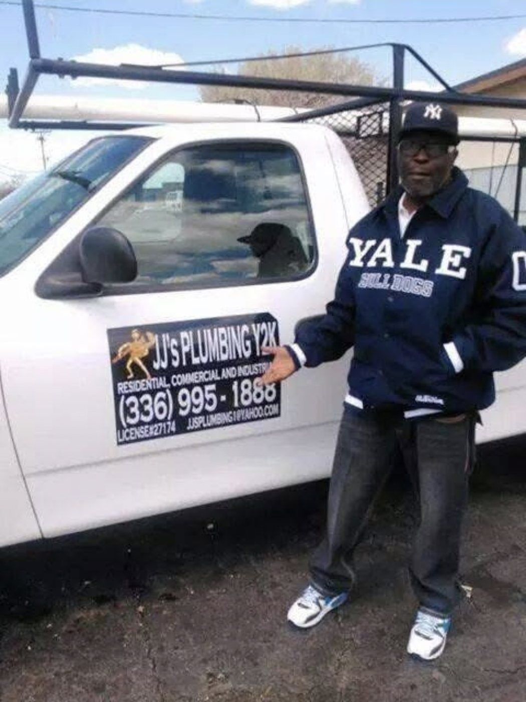 JJ's Plumbing Y2K team member beside the plumbing service vehicle