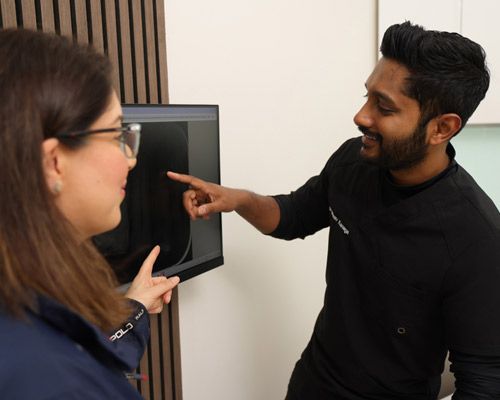 Dentist and patient discussing dental X-rays at Hawthorn Dental Hub