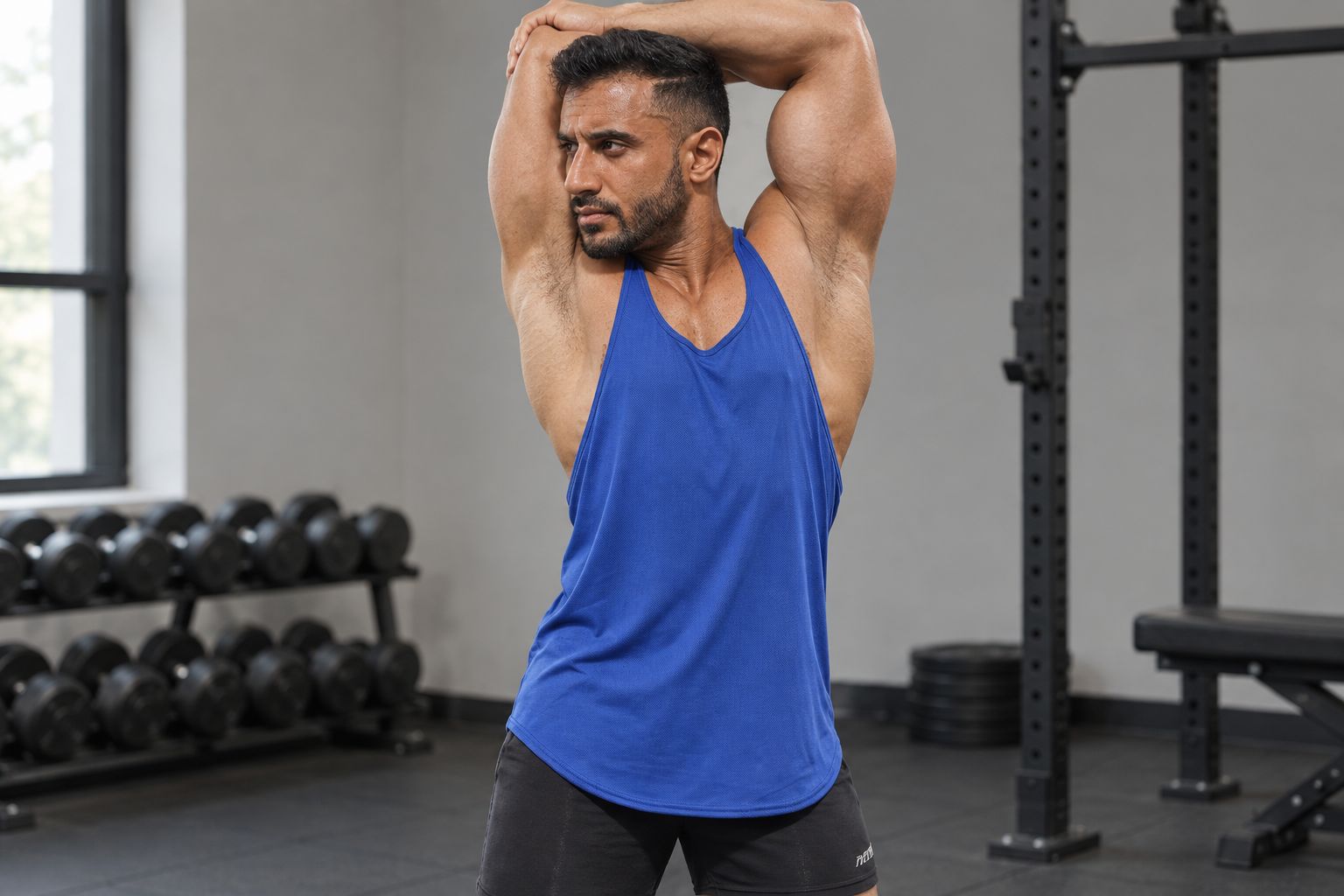 Gym-goer checking how a stringer tank sits during an overhead stretch