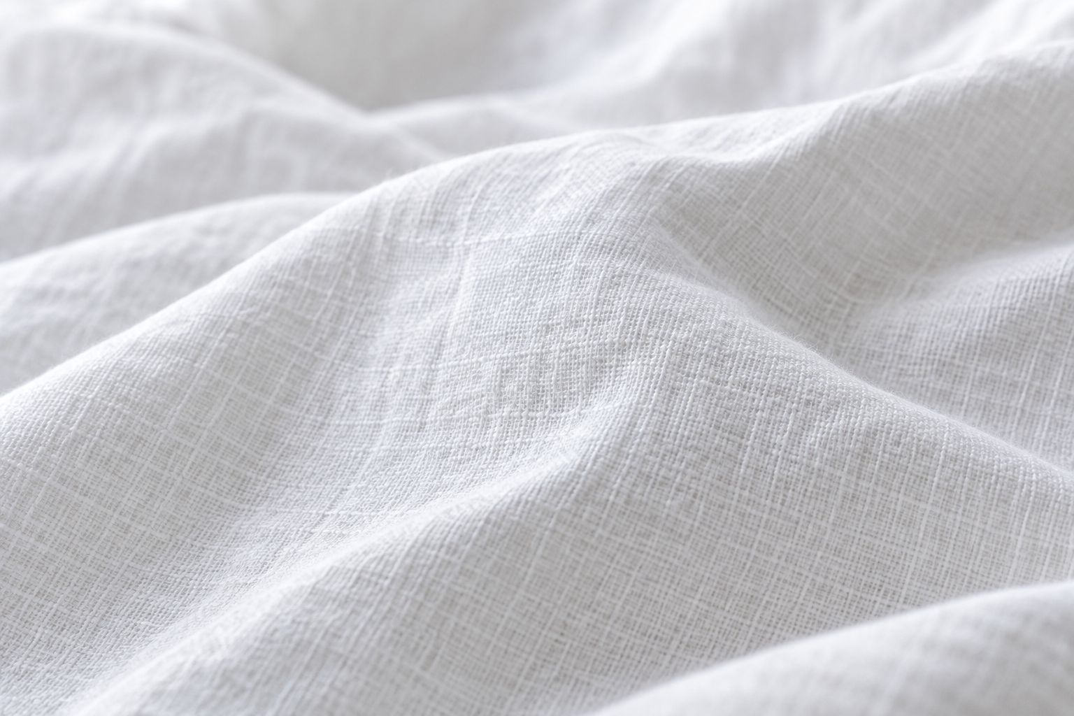 Close-up texture of a plain-weave cotton sheet