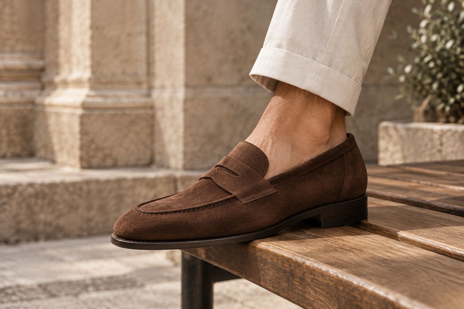 Suede penny loafer on a wooden bench showing the texture of the nap
