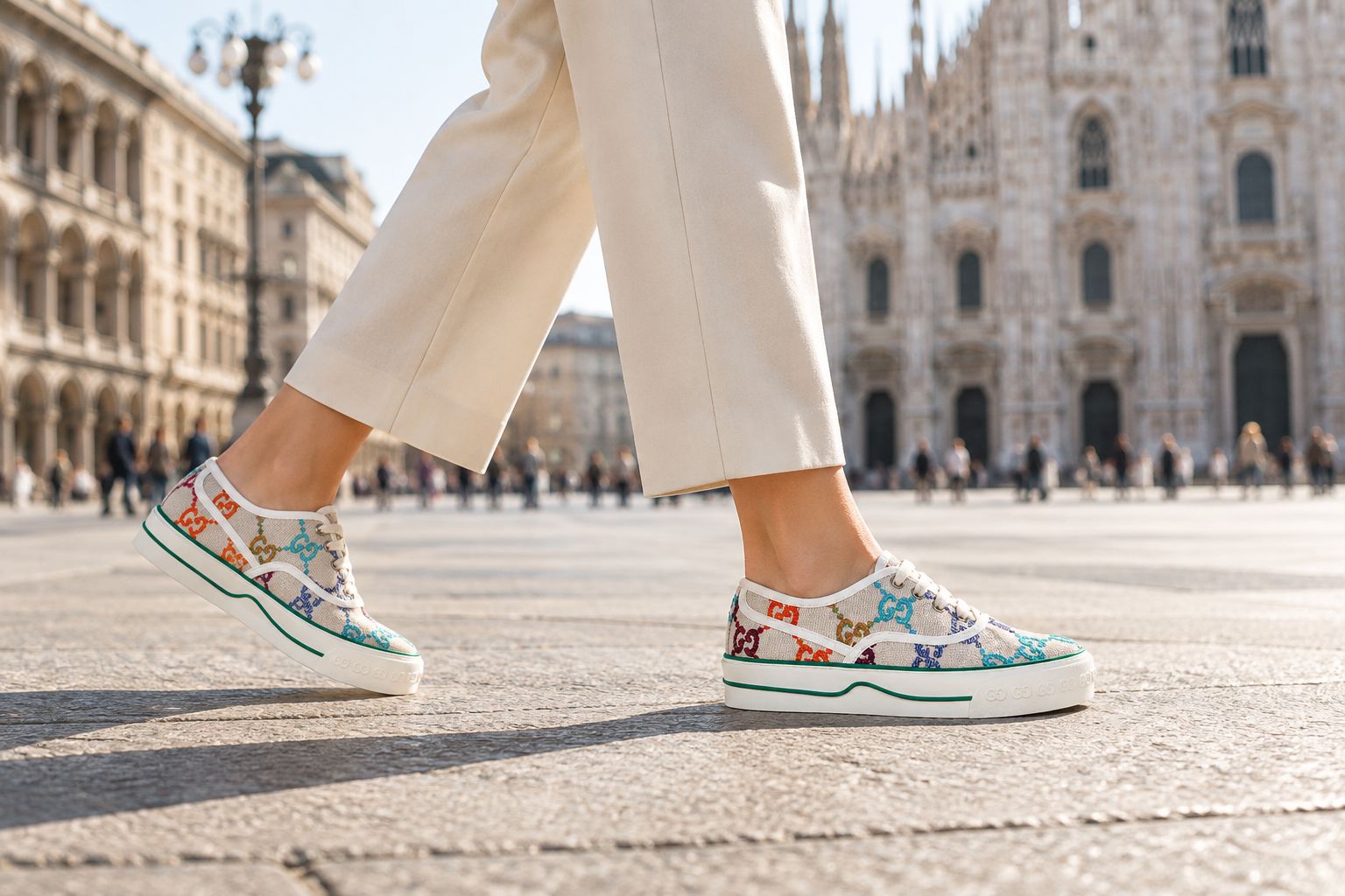 Woman wearing multicolor Gucci canvas sneakers with tailored trousers
