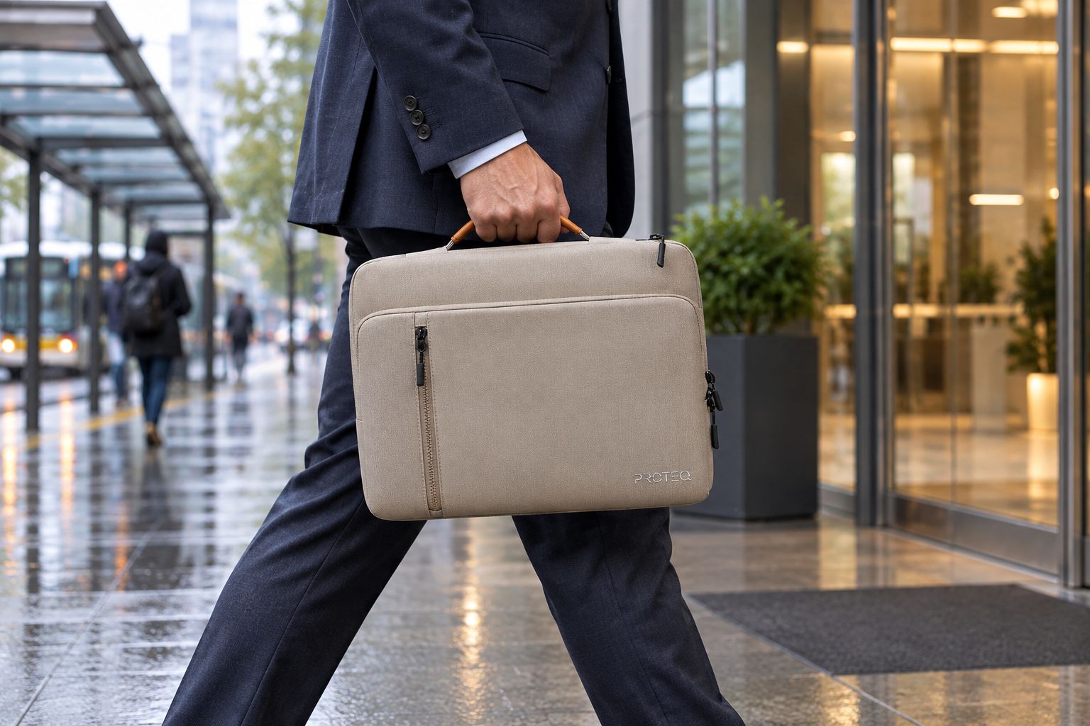 Laptop bag carried from a covered transit stop on a wet commute