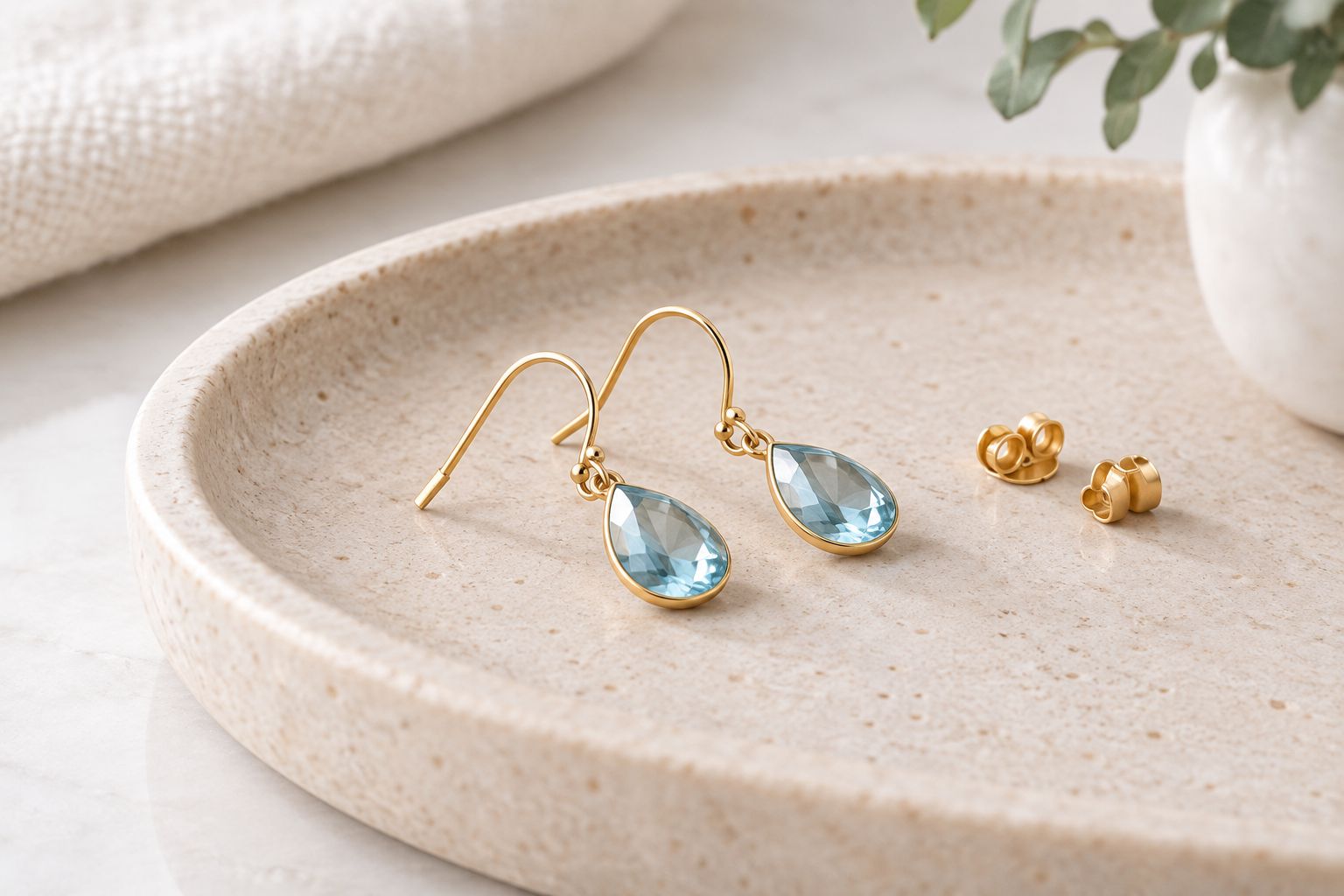 Gemstone earrings and backs arranged to show the parts that touch the ear