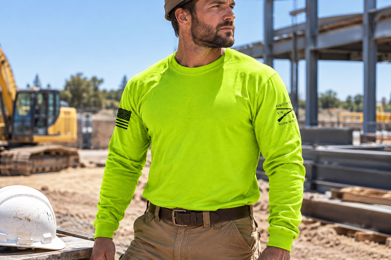 Worker wearing a safety green long sleeve shirt on a sunlit job site