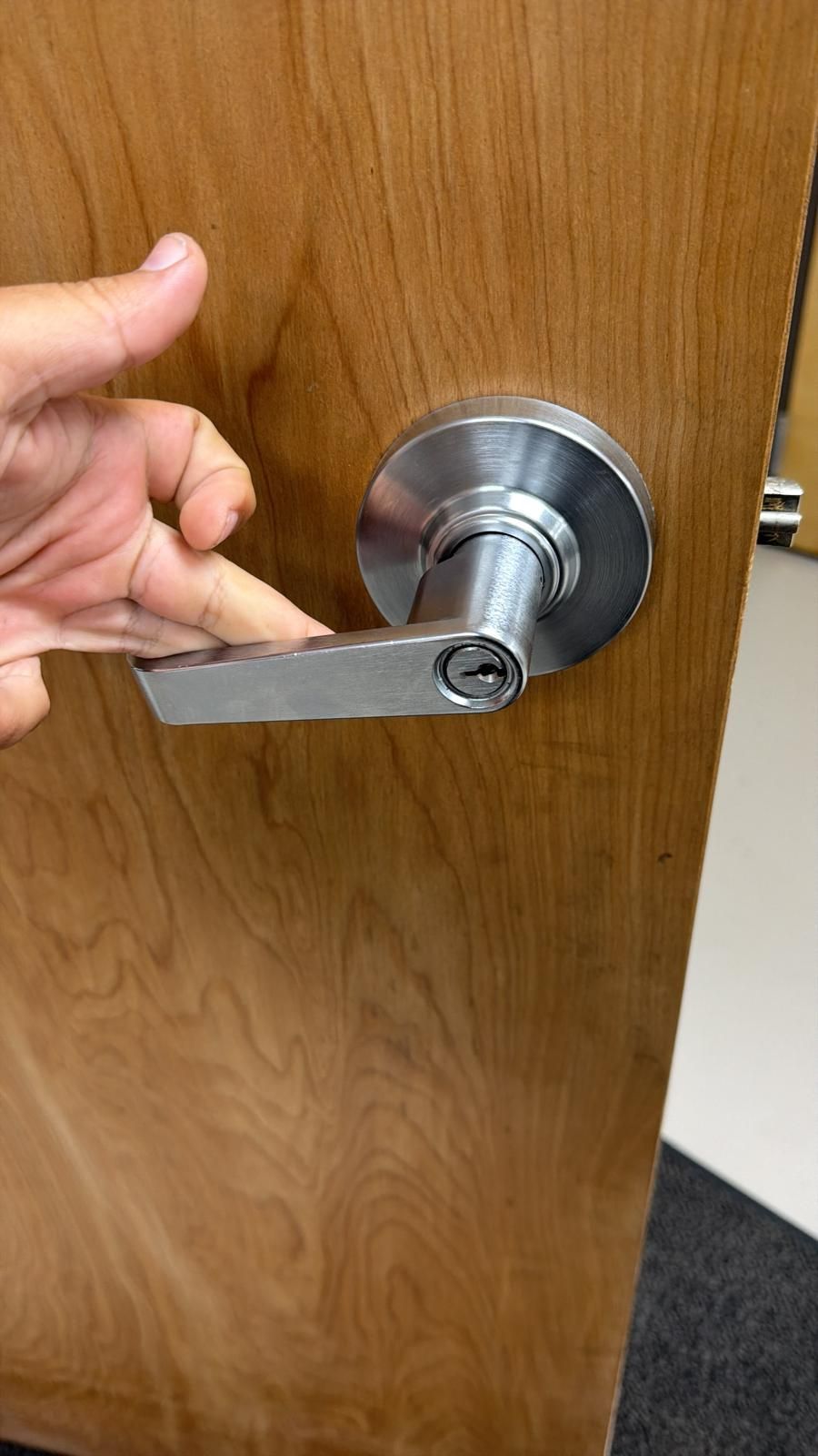 Keyed lever handle on a wooden door
